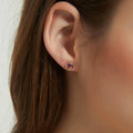 Model wearing Solitaire Kaleidoscope CZ Stud Earrings in Sterling Silver 1.6ct, Red Orange Color