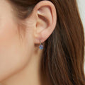 Model wearing Kaleidoscope Solitaire CZ Leverback Earrings in Sterling Silver, Purple Aqua Color