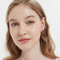 Model wearing Cross CZ Stud Earrings in Sterling Silver, Red Color