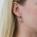 Model wearing Halo Kaleidoscope CZ Fish Hook Earrings in Sterling Silver, Red Orange Color