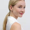 Model wearing Halo CZ Stud Earrings in Sterling Silver, Rose Gold Flashed