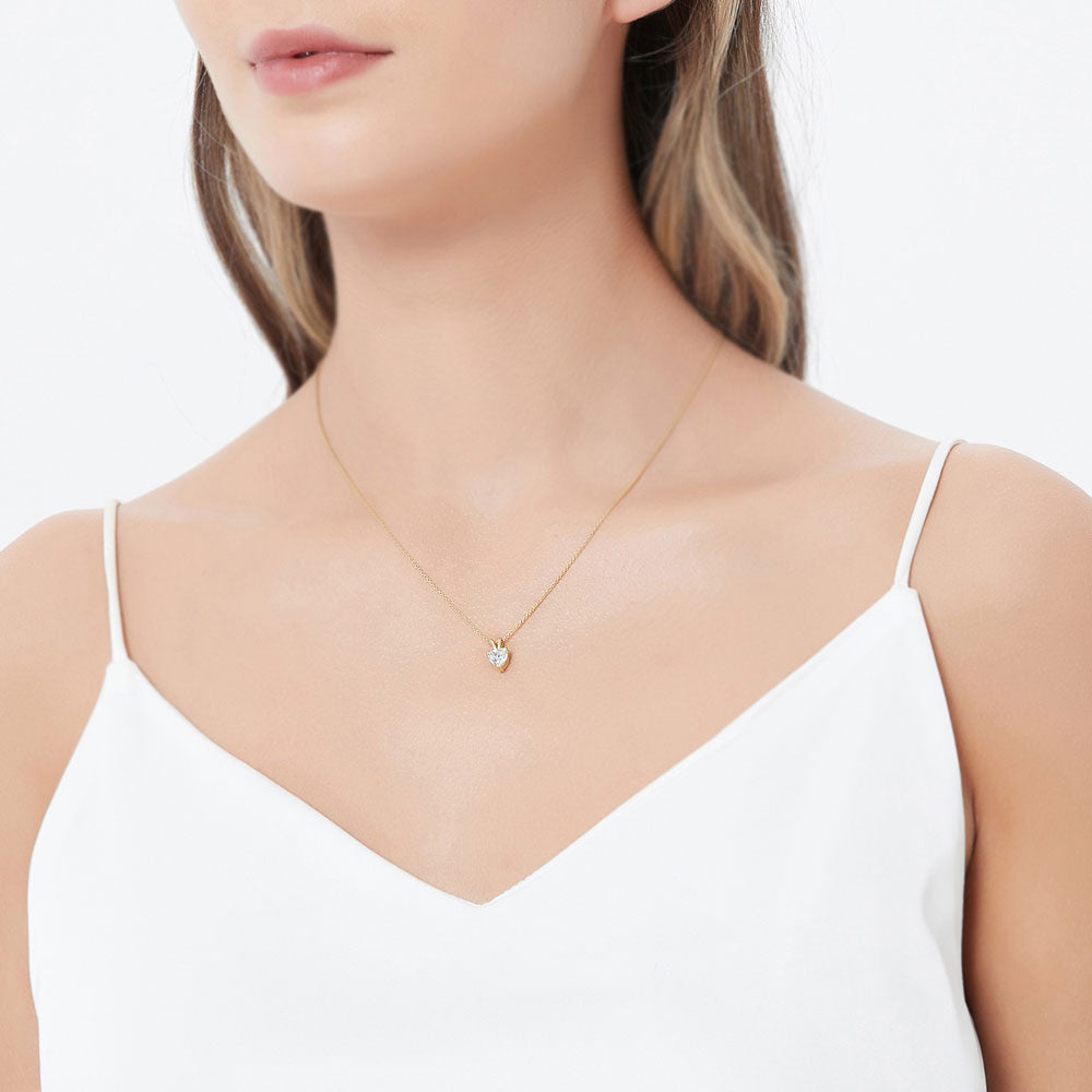 Model wearing Solitaire Heart Heart CZ Necklace in Gold Flashed Sterling Silver, 3 of 6