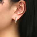 Model wearing Bar CZ Medium Inside-Out Hoop Earrings in Sterling Silver 0.75 inch, Rose Gold Flashed