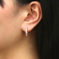 Model wearing Bar CZ Medium Inside-Out Hoop Earrings in Sterling Silver 0.75 inch, Rose Gold Flashed