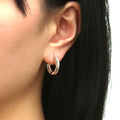 Model wearing Bar CZ Medium Inside-Out Hoop Earrings in Sterling Silver 0.75 inch, Rose Gold Flashed