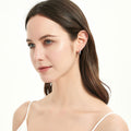 Model wearing Solitaire CZ Medium Hoop Earrings in Sterling Silver 0.64 inch, Rhodium Plated