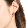 Model wearing Solitaire CZ Medium Hoop Earrings in Sterling Silver 0.64 inch, Rhodium Plated