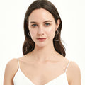 Model wearing Bar CZ Medium Hoop Earrings in Sterling Silver, 1 inch