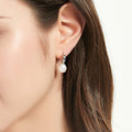 Model wearing Solitaire Cultured Pearl Stud Earrings in Sterling Silver, Yellow Gold Flashed