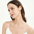 Model wearing Solitaire Cultured Pearl Stud Earrings in Sterling Silver, Yellow Gold Flashed