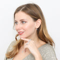 Model wearing Solitaire Emerald Cut CZ Leverback Earrings in Sterling Silver, Yellow Gold Flashed