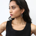 Model wearing CZ Large Inside-Out Hoop Earrings in Sterling Silver 1.8 inch, Yellow Gold Flashed