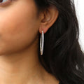 Model wearing CZ Large Inside-Out Hoop Earrings in Sterling Silver 1.8 inch, Yellow Gold Flashed