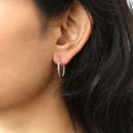 Model wearing Cable Medium Hoop Earrings in Sterling Silver 0.68 inch, Yellow Gold Flashed