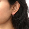 Model wearing Cable Medium Hoop Earrings in Sterling Silver 0.68 inch, Yellow Gold Flashed