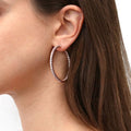 Model wearing CZ Large Inside-Out Hoop Earrings in Sterling Silver 1.9 inch, Rose Gold Flashed