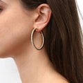 Model wearing CZ Large Inside-Out Hoop Earrings in Sterling Silver 1.9 inch, Yellow Gold Flashed