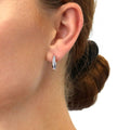 Model wearing Bar CZ Medium Hoop Earrings in Sterling Silver 0.64 inch, Rhodium Plated