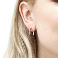 Model wearing Hexagon Medium Hoop Earrings in Sterling Silver 0.79 inch, Rhodium Plated