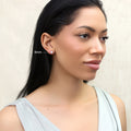 Model wearing Solitaire CZ Stud Earrings in Gold Flashed Sterling Silver, 5mm