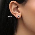 Model wearing Solitaire Bezel CZ Stud Earrings in Gold Flashed Sterling Silver, 6mm