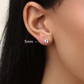 Model wearing Solitaire Bezel CZ Stud Earrings in Gold Flashed Sterling Silver, 4mm