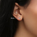 Model wearing Solitaire Bezel CZ Stud Earrings in Gold Flashed Sterling Silver, 4mm