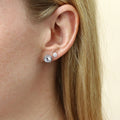 Model wearing Halo CZ Stud Earrings in Sterling Silver, Rhodium Plated