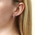 Model wearing Bar CZ Medium Hoop Earrings in Sterling Silver, 0.6 inch