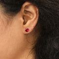 Model wearing Solitaire CZ Stud Earrings in Sterling Silver 1.6ct, Ruby Color